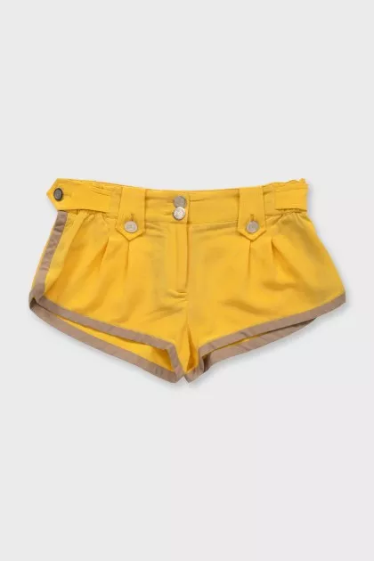 Yellow shorts with gold buttons