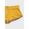 Yellow shorts with gold buttons