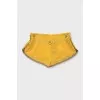 Yellow shorts with gold buttons