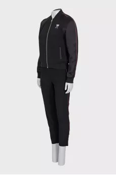 A suit consisting of a T-shirt, jacket, and trousers with trim