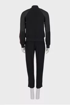 A suit consisting of a T-shirt, jacket, and trousers with trim