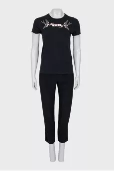 A suit consisting of a T-shirt, jacket, and trousers with trim