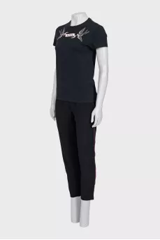 A suit consisting of a T-shirt, jacket, and trousers with trim
