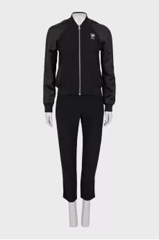 A suit consisting of a T-shirt, jacket, and trousers with trim
