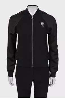 A suit consisting of a T-shirt, jacket, and trousers with trim