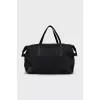 Black textile bag with a signature print