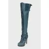 Leather over-the-knee boots decorated with buckles