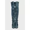 Leather over-the-knee boots decorated with buckles
