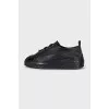 Black sneakers with patent toes