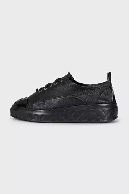 Black sneakers with patent toes
