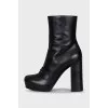 Leather ankle boots decorated with a strap