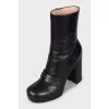 Leather ankle boots decorated with a strap