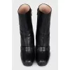 Leather ankle boots decorated with a strap