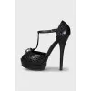 Black leather sandals with gold decor