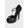 Black leather sandals with gold decor