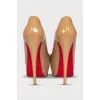 Beige high-heeled shoes