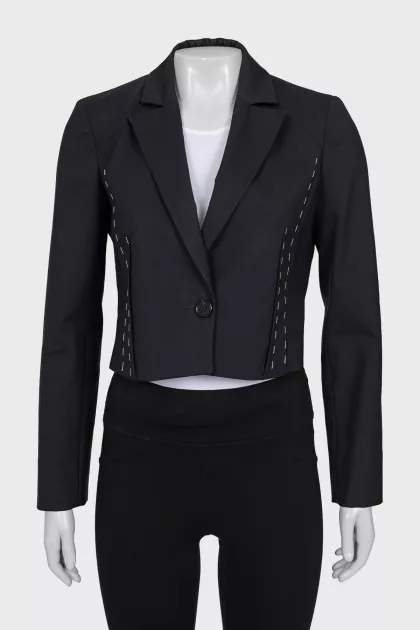 A cropped jacket decorated with chains