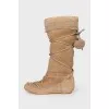 Suede boots decorated with pom-poms
