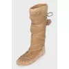 Suede boots decorated with pom-poms
