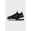 Black sneakers with embossed logo