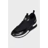 Black sneakers with embossed logo
