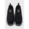Black sneakers with embossed logo