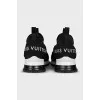 Black sneakers with embossed logo