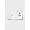 White textile sneakers with a brand logo