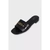Black leather flip-flops with gold trim
