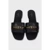 Black leather flip-flops with gold trim