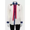 Straight blouse decorated with embroidery