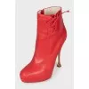 Red leather ankle boots with perforations