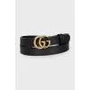 Narrow leather belt with a gold buckle