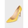 Patent leather yellow pumps