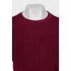 Red sweater with a tag