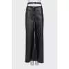 Faux leather trousers with a cutout