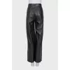 Faux leather trousers with a cutout