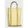 Yellow leather bag with studs