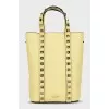Yellow leather bag with studs