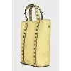 Yellow leather bag with studs