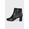 Black ankle boots with a trapezoid heel