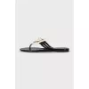 Black rubber flip-flops decorated with a flower