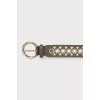 Leather belt decorated with eyelets