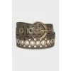Leather belt decorated with eyelets