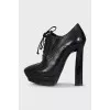 Black leather ankle boots with perforations