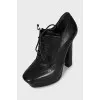 Black leather ankle boots with perforations