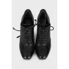 Black leather ankle boots with perforations