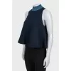 Sleeveless top with a high collar