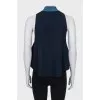 Sleeveless top with a high collar
