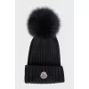 Black hat with a pompom